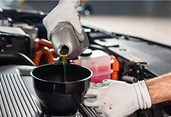 Mechanic pouring engine oil